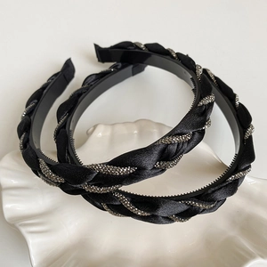 Close-up of black braided headband with crystals and anti-slip teeth detail