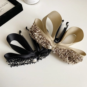 Elegant bow-knot banana hair clips in black and champagne gold with pearl accents