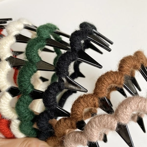Detail view of colorful knitted wool wavy hairbands with non-slip toothed plastic base