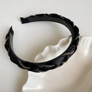 Detail of black braided satin headband with small rhinestones and non-slip inner teeth