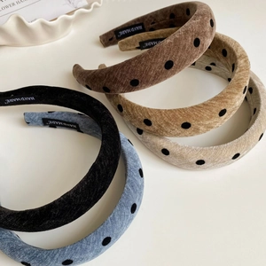 Close-up of vintage polka dot padded headbands with soft velvet texture and handmade labels