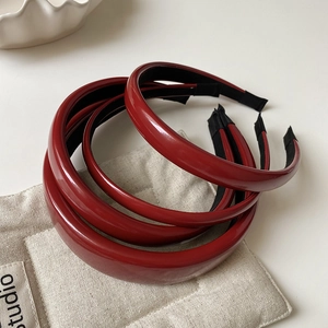 Set of four shiny red faux leather headbands with a high-gloss finish for women