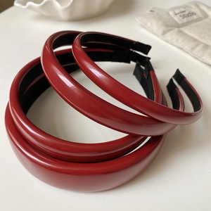 Three assorted sizes of vintage red leather headbands with glossy finish and black lining