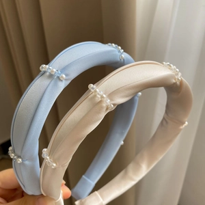 Close-up of light blue and cream padded headbands with pearls and crystal beads detail
