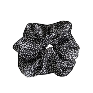Polka dot oversized scrunchie in black and white satin finish with pleated details