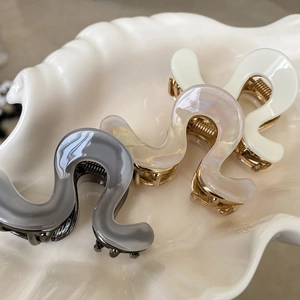 Three premium acetate shark hair claws in wave design, set in gray, beige and ivory white