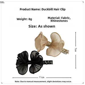 Detailed view of lace bow hair clips in beige and black with rhinestones and dimensions