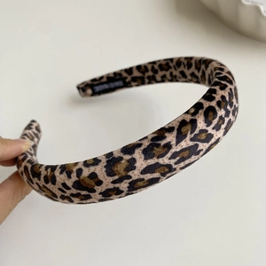 Close-up of handmade leopard print velvet headband showing soft texture and thickness
