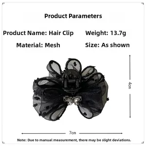Detail view of black mesh polka dot bow hair claw with rhinestones, size 7x4cm
