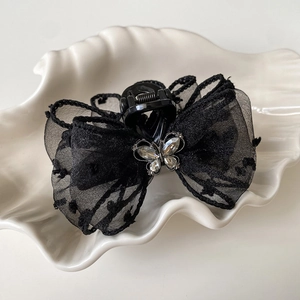 Elegant black mesh polka dot bow hair claw with sparkling rhinestone butterfly accent