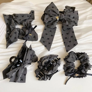 Five-piece gray bow hair accessories set including scrunchies and shark clips
