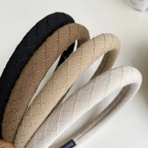 Detail of quilted fabric headbands in black, brown, khaki, and cream colors