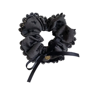 Grey scrunchie with black lace trim and golden bow pendant accessory for hair styling