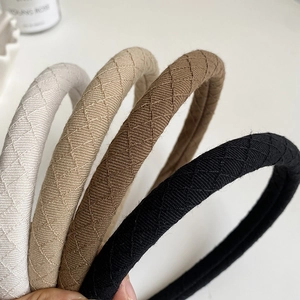 Quilted fabric padded headbands in white, beige, brown, and black colors for women