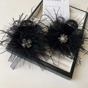 Elegant pair of 8cm black feather hair claws with rhinestone flower and mesh detail