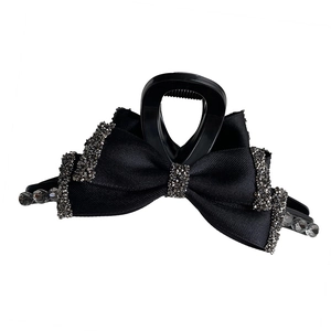 Elegant French vintage black satin bow hair claw clip with rhinestones on white background