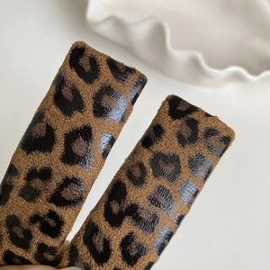 Detailed macro view of the vintage leopard print fabric texture on a stylish hair clip