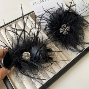 Elegant black feather hair claw clip with satin rose and sparkling rhinestones
