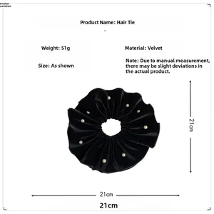 Detail view of extra large black velvet hair scrunchie with pearls measuring 21cm in size