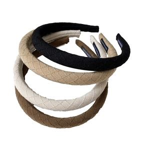 Quilted fabric headbands in assorted colors like black and khaki with handmade labels