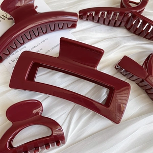 Detailed collection of glossy burgundy red hair claws in various geometric shapes