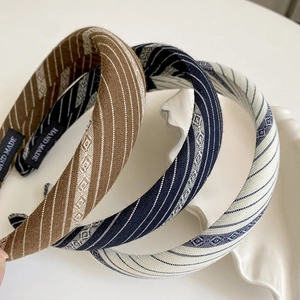Maillard striped wide headbands in brown, navy, and beige with handmade woven label