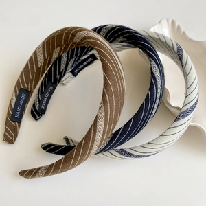 Three-piece set of striped fabric headbands in brown, navy, and beige for women