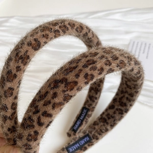 Vintage leopard print padded headband with fuzzy texture and handmade label for women
