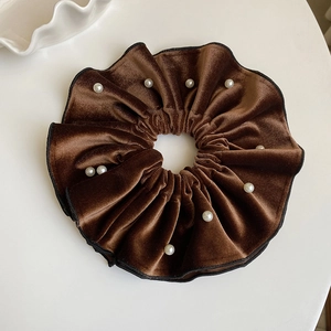 Detail of vintage brown velvet hair scrunchie with white pearls and black edging