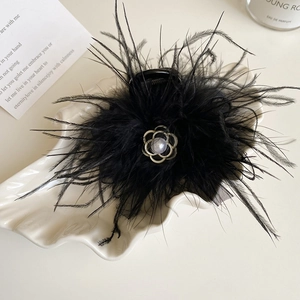Elegant black feather hair claw with camellia flower and pearl in a vintage style