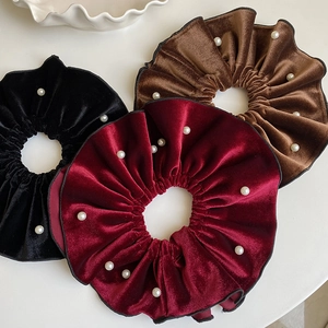 Oversized velvet scrunchies with faux pearl embellishments in black brown and red