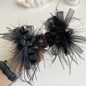Elegant camellia feather claw clip with black organza ribbon for premium hair styling