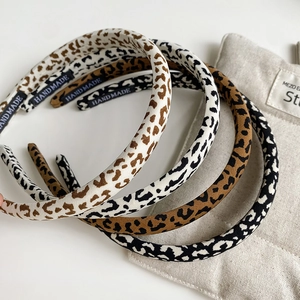Three stylish leopard print slim headbands in beige, brown and grey with handmade label
