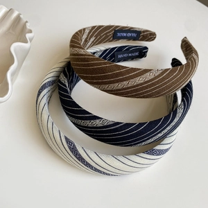 Close-up of handmade striped fabric headbands showing premium texture and craftsmanship