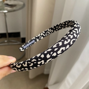 Detailed close-up of a handmade black and white leopard print fabric sponge headband
