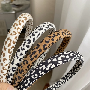 Close-up detail of assorted leopard print fabric headbands in various natural color tones