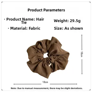 Detail view of brown fabric scrunchie showing 18cm diameter and 29.5g weight specifications