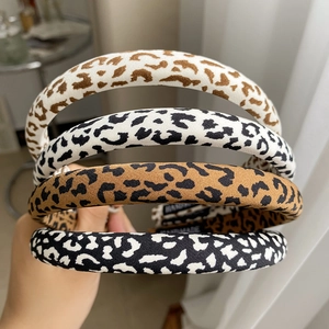 Detail of four handmade leopard print headbands showing fabric texture and patterns