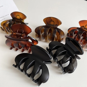 Medium matte shark hair clips in assorted black and tortoise shell patterns for women