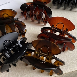 Medium matte finish shark hair claw clips in classic amber and black for thick hair