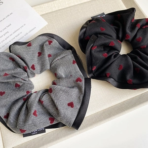 Retro heart pattern scrunchies in black and gray with satin trim and woven label