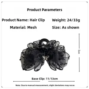 Detailed view of black mesh hair claw with bow and butterfly metal ornament