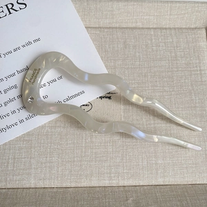 Detail of wavy acetate U-shaped hair pin with rhinestone and France handmade text