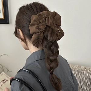 Deep brown oversized scrunchie on dark braided hair showing rich pleated texture