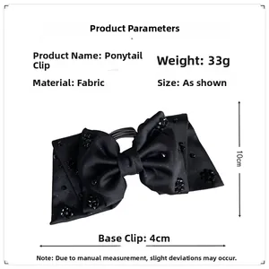 Detail view of black satin bow ponytail clip with beads, height 10cm and base clip 4cm