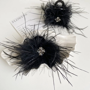 Elegant black feather hair claw set with mesh bows and rhinestone heart details