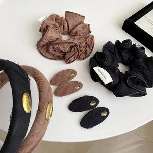 Vintage style brown and black fabric hair accessories set with gold label accents