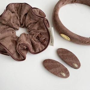 Detailed set of brown vintage fabric hair scrunchie, headband, and metallic BB clips