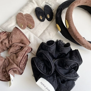 Vintage fabric hair accessories set with gold metal labels and distressed textured fabric