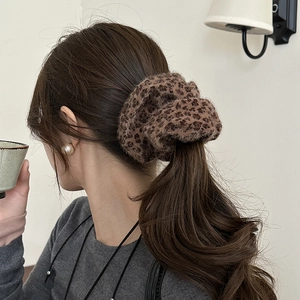 Leopard print plush scrunchie worn on ponytail for autumn and winter hairstyle